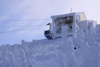 A Hakkoda Ropeway cable car seeks refuge from the snow monsters in the frost-covered station.