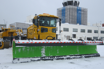 One of White Impulse's snowplows with the Aomori Airport terminal building in the background.