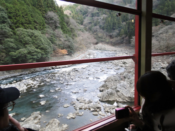 Passengers enjoy views of the Hozu River from the Sagano Scenic Railway