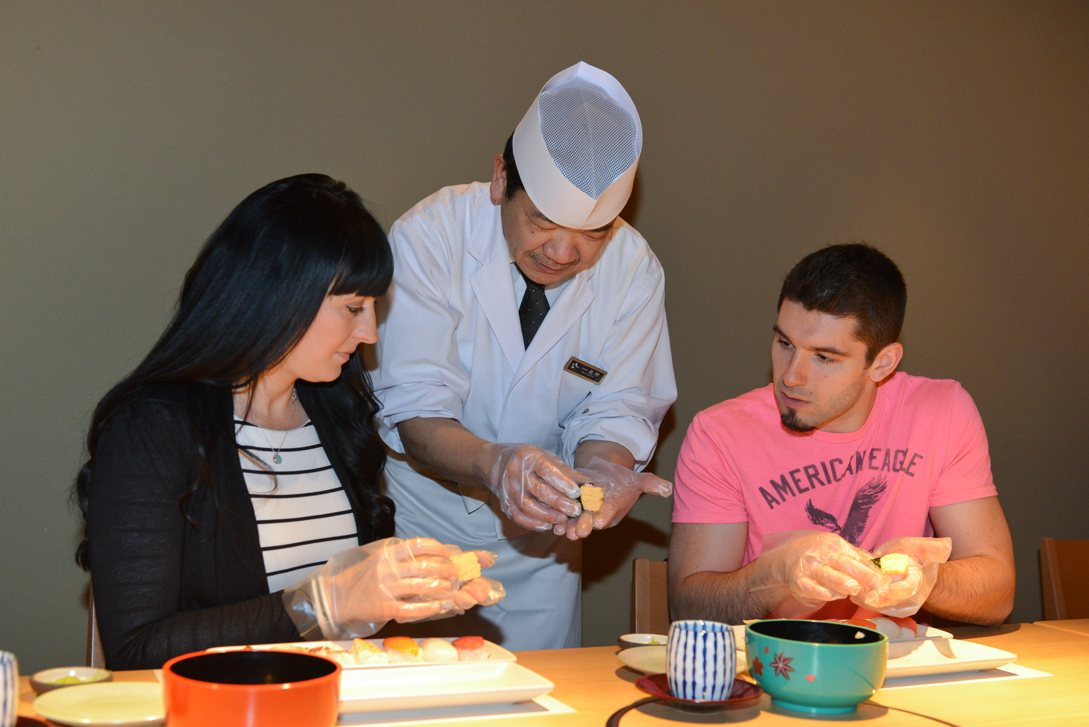 Visitors experience making sushi at Hassan in Tokyo.